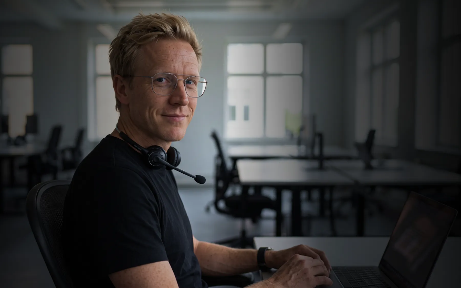 Bright open-plan AG360 studio with a consultant at his desk